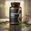 Ashwagandha capsules bottle on a wooden table with raw roots and green leaves in Pakistan.