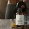 A side-by-side comparison of Applied Nutrition Test X, a Tribulus Terrestris extract bottle, and ABE pre-workout on a rustic wooden table with muscular athletes in the background.